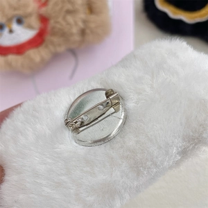 Detailed back view of white plush brooch with secure metal pin for DIY accessory