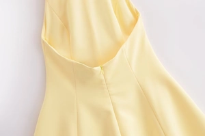 Detailed close-up of halter dress back with open-back cut and invisible zipper
