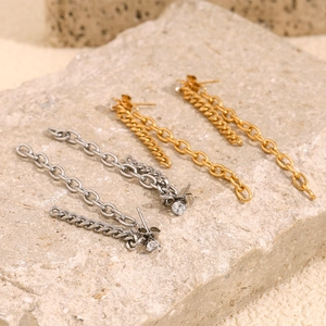 Detailed view of long chain drop earrings in gold and silver with cubic zirconia studs