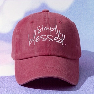 Detail of white Simply Blessed embroidery and cross on a vintage red cotton baseball cap