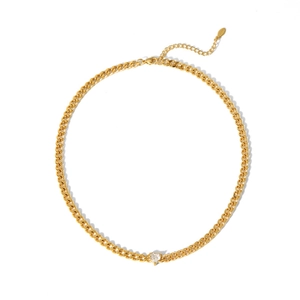 Macro detail of 18K gold plated Cuban chain necklace featuring a heart-shaped zircon stone
