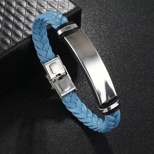 Detail of blue braided leather bracelet featuring a polished stainless steel metal plate