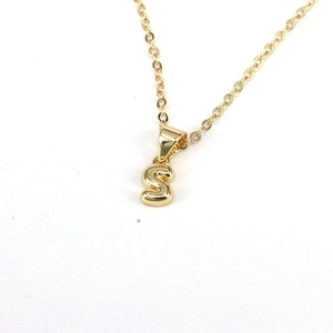 Minimalist gold necklace with a polished letter S pendant on a fine chain for women
