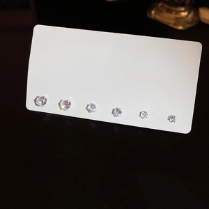 Detailed view of a six-piece round zircon stud earring set on a white display card
