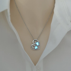 Detail of a glowing heart turtle necklace engraved with I love you forever text on model