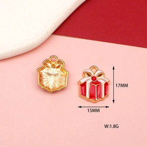 Macro shot of 15mm Christmas gift box pendants with red enamel and rhinestone details