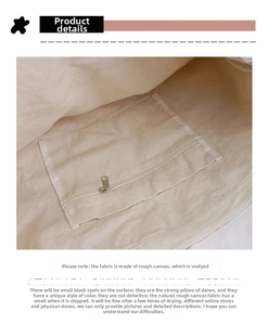 Detailed interior of a vintage canvas tote showing zip pocket and natural cotton texture
