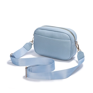 Light blue faux leather crossbody camera bag with wide strap and gold hardware accents
