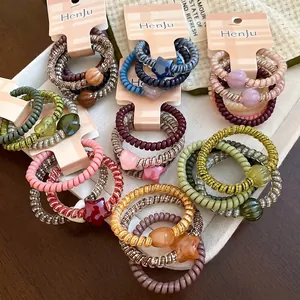 Set of spiral telephone cord hair ties with star and bead charms in assorted colors