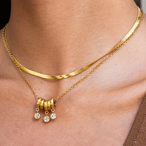18K gold plated double layer necklace with snake chain and zircon circles on a model