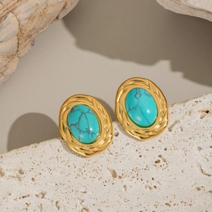 Élégantes boucles d'oreilles en acier doré avec turquoise ovale sur socle en pierre