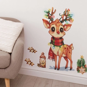 Detail of Christmas reindeer wall sticker with stars and lantern on a white living room wall