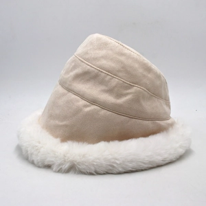 Detailed view of winter plush bucket hat with beige suede fabric and faux fur trim