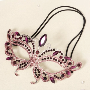 Detail of butterfly masquerade mask with pink and purple rhinestones on silver frame