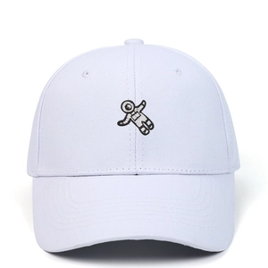 Close-up of white cotton baseball cap showing detailed astronaut embroidery pattern