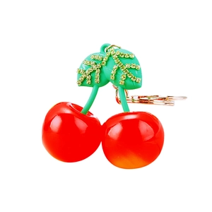 Red resin cherry keychain with green rhinestones and golden metal ring for women