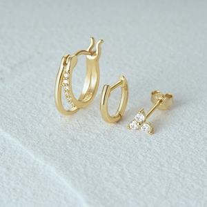 Detailed view of 3-piece set featuring gold-plated silver hoops and CZ stud earrings