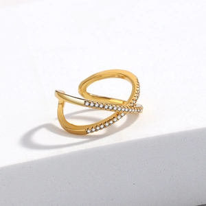 Detailed close-up of a crossover X-ring with pavé crystals in 18K gold finish