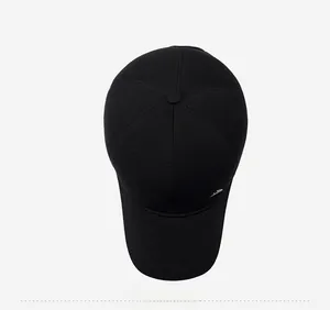 Top view of a classic black winter baseball cap showing textured fabric and metal logo