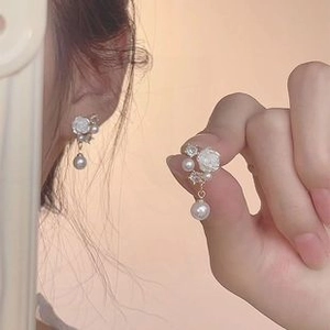 Detailed view of French Baroque floral stud earrings with rhinestones and pearl drops