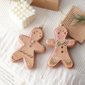 Christmas gingerbread man pendants with festive hand-painted details and golden hanging cords