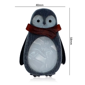 Detail view of acrylic penguin brooch showing 58mm x 40mm dimensions and marble texture