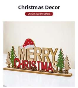 Close-up of wooden Merry Christmas desk ornament with pine cones and miniature trees