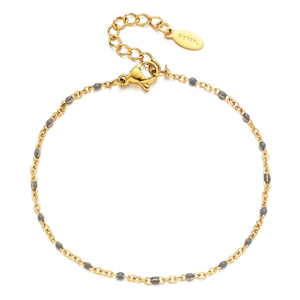 Detail of gold stainless steel chain with grey beads and heart engraved extension tag