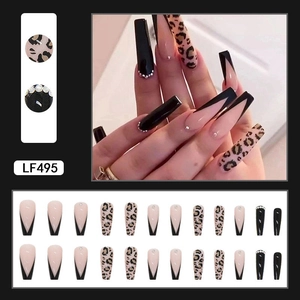 Close-up of long coffin fake nails with leopard print, nude V-French tips, and rhinestones