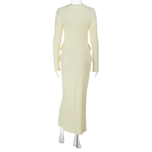 Detail of light yellow knit long sleeve dress showing slim fit and ribbed fabric texture