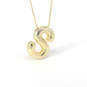 Polished gold balloon letter S pendant necklace with shiny mirror finish on white background