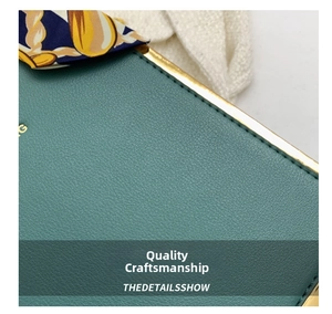 Detail of dark green pebble leather texture with gold metal trim and silk scarf accent