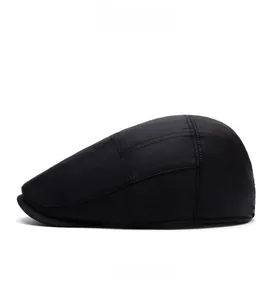 Side view of black insulated newsboy cap showing textured fabric and stitching