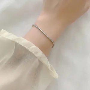 Close-up of S925 sterling silver tennis bracelet with round moissanite on a wrist