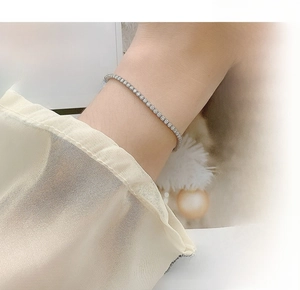 Close-up of S925 sterling silver tennis bracelet with round moissanite on a wrist