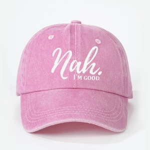 Close-up of embroidered white lettering Nah I'M GOOD on pink washed cotton baseball cap