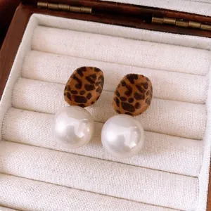 Retro leopard print flocked earrings with large white pearls in a white jewelry display box