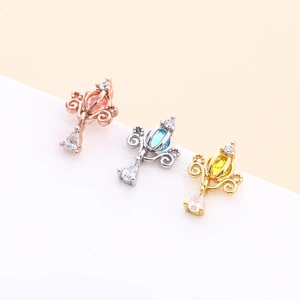 Three crown-shaped ear studs in rose gold, silver, and gold with colorful teardrop gems