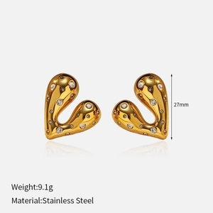 Detailed view of 18k gold plated heart earrings with sparkling cubic zirconia inlay
