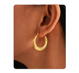 Detailed close-up of 18k gold plated U-shaped earrings with woven checkered texture