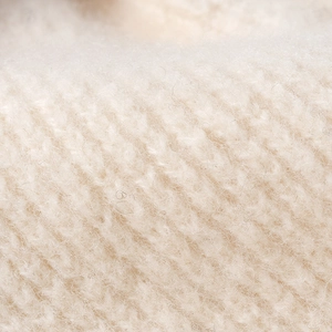 Close-up of beige ribbed knit beanie made of soft mohair wool blend for autumn warmth