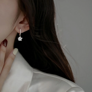 S925 Sterling silver star hoop earrings with zircon accents worn by a female model