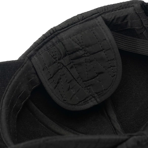 Close-up of winter hat's quilted lining with thick fleece and elastic ear flaps