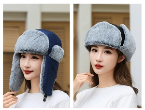 Detail of navy windproof earflap hat showing the plush grey faux fur and buckle