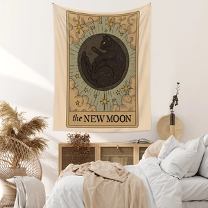 Detail of tarot style tapestry featuring a black cat in the moon with the New Moon text