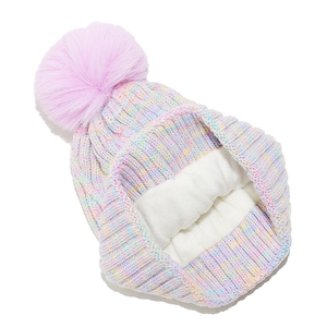 Detail of colorful knitted winter hat featuring thick fleece lining and pink faux fur pompom