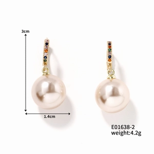Detail view of round pearl earrings with gold clasp and multicolored zircon inlays