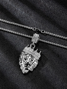 Macro shot of silver hip-hop lion head pendant with iced-out crown and twisted chain