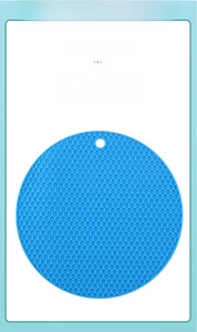 Detail of blue silicone honeycomb mat with a hanging hole and heat-resistant texture