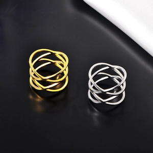 Close-up of gold and silver stainless steel double crisscross hollow rings for women